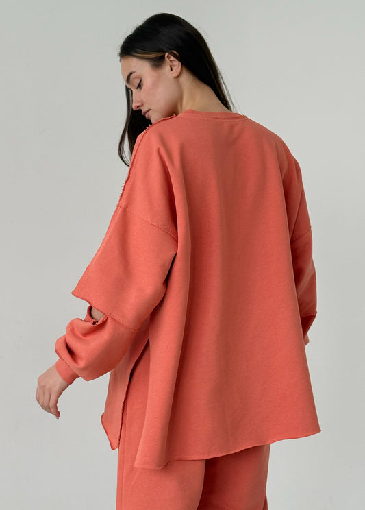 Apricot cotton sweatshirt with a ripped elbow