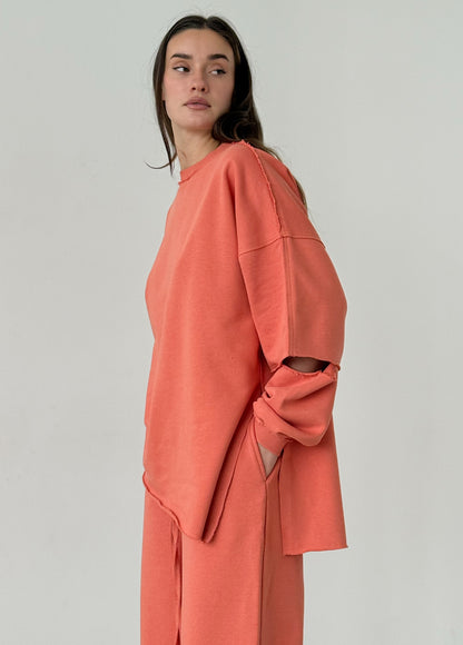 Apricot cotton sweatshirt with a ripped elbow