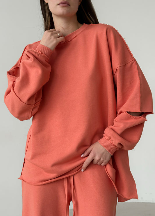 Apricot cotton sweatshirt with a ripped elbow