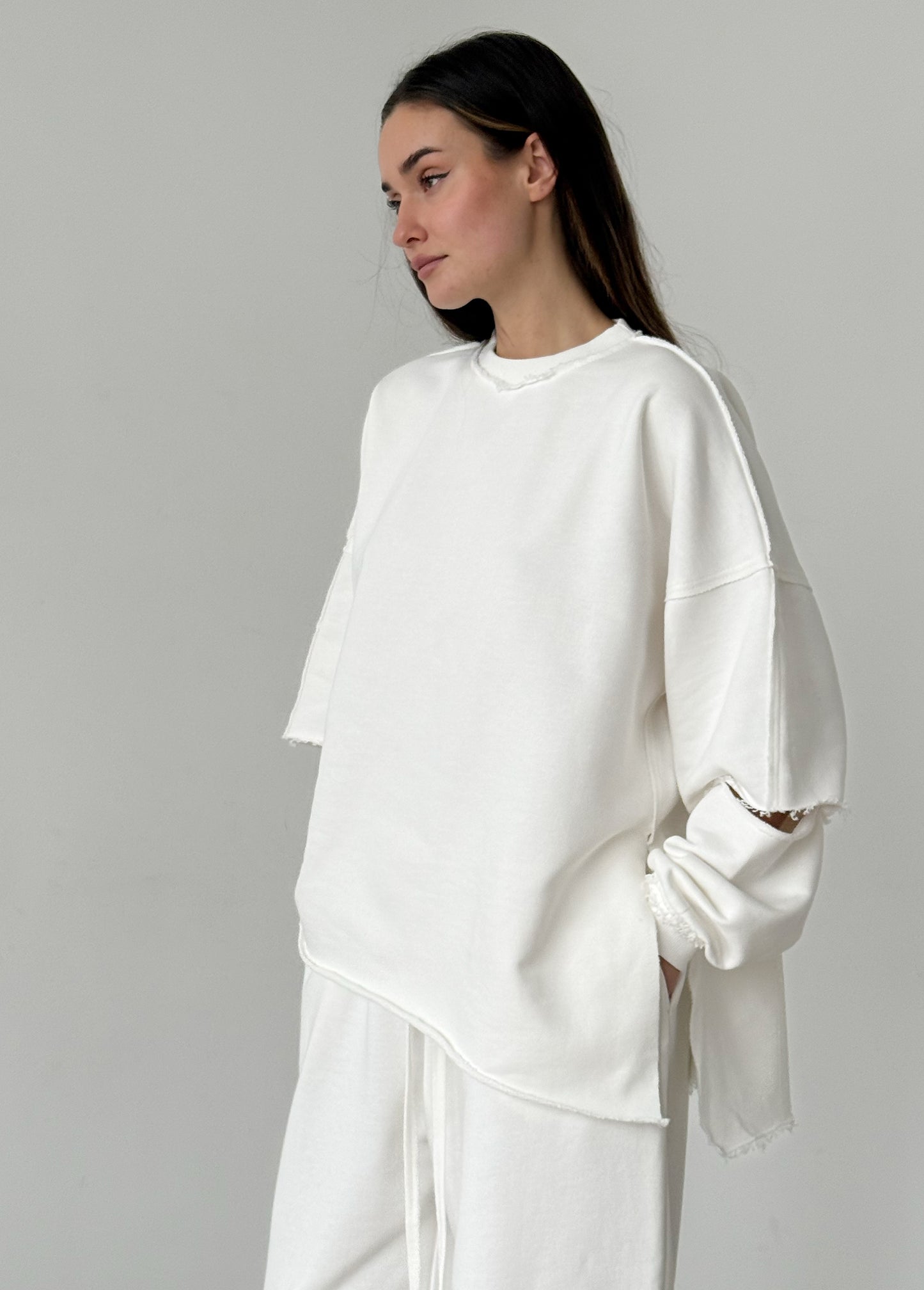 White cotton sweatshirt with a ripped elbow
