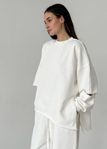 White cotton sweatshirt with a ripped elbow