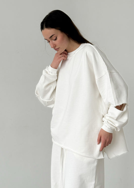White cotton sweatshirt with a ripped elbow