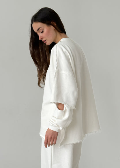 White cotton sweatshirt with a ripped elbow