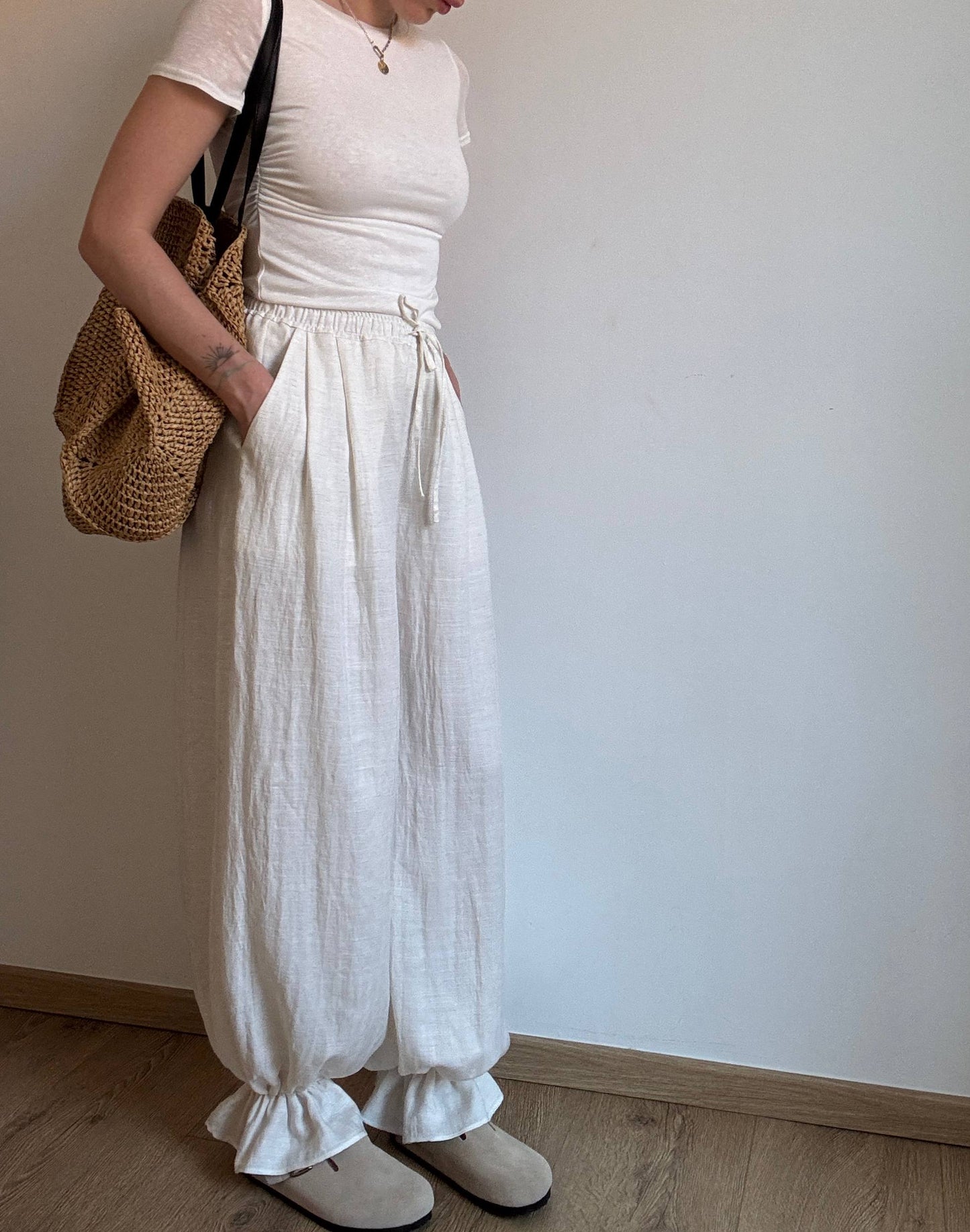 Natural trousers with ruffle detail
