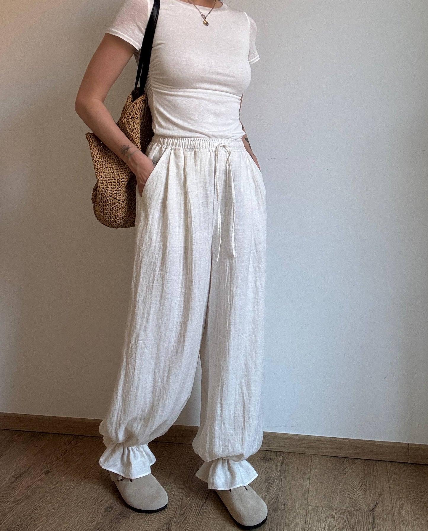 Natural trousers with ruffle detail